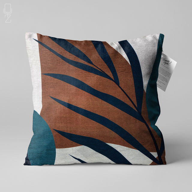 Front view of a leaf theme double sided printed pillow cover in brown, blue, white and black.