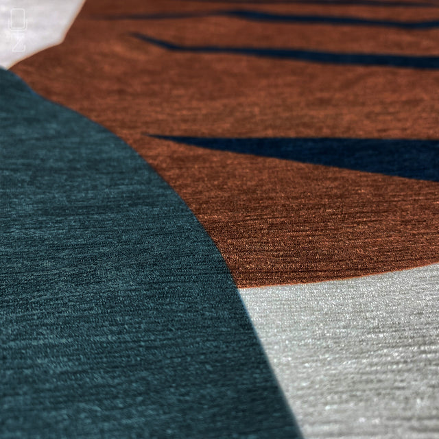 Zoomed-in view of brown, black, green and white leaf themed printed throw pillow cover.